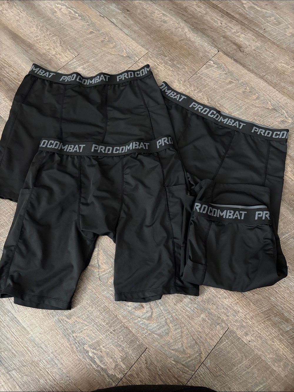 Black "Pro Combat" athletic compression shorts or tights with a branded elastic
